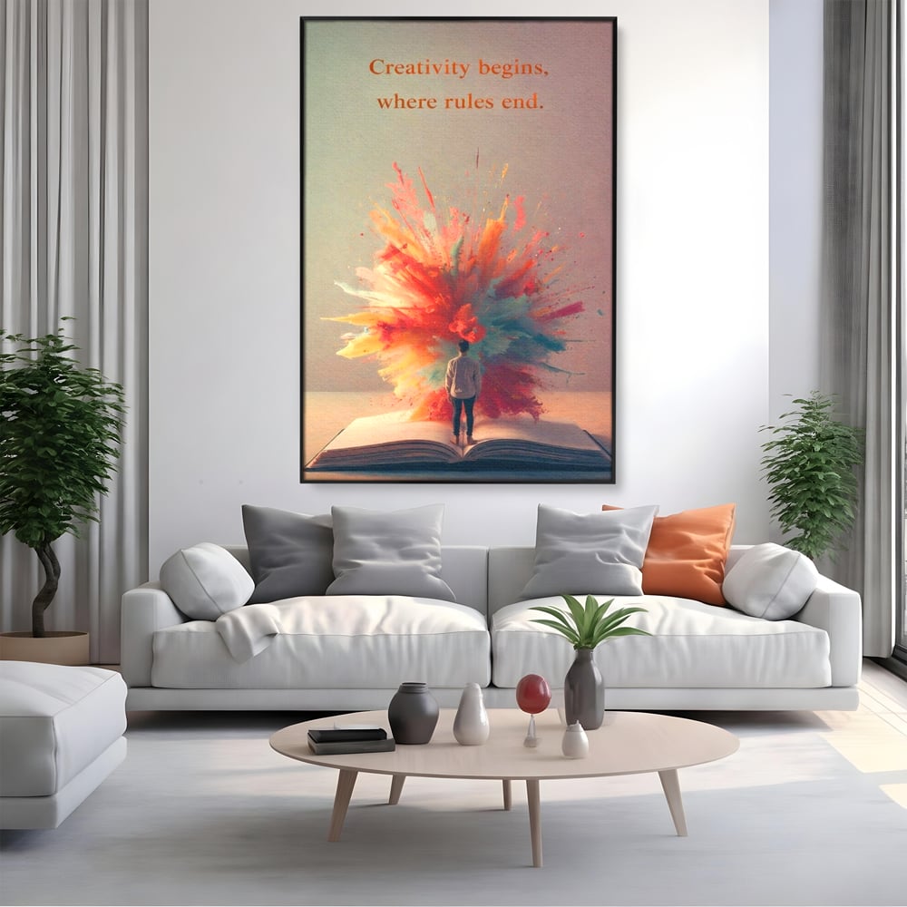 Tablou canvas cu tablou canvas cu barbat privind o explozie de culoare dintr-o carte deschisa, in rama de aluminiu negru, pe perete intr-un living